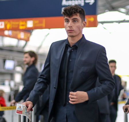 Kai Havertz in a black suit caught on the camera while boarding on a plane.